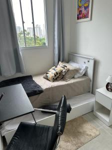 a bedroom with a bed with a chair and a window at M.APTO barra funda in São Paulo