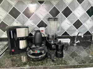 a kitchen counter with a blender and a coffee maker at M.APTO barra funda in São Paulo