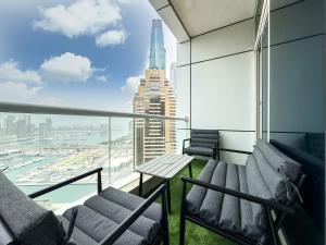 a balcony with chairs and a view of the city at 2-BDR, Dubai Marina, Canal and city view in Dubai