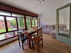 a living room with a table and chairs and a couch at Apartamento céntrico Llanes in Llanes