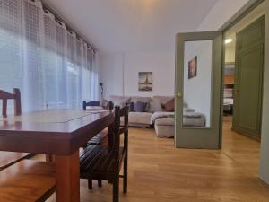 a living room with a table and a couch at Apartamento céntrico Llanes in Llanes +3 photos