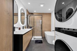a bathroom with a tub and a sink at Le Chamonix/Mountain view/Golf course/Activities! in Saint-Faustin +82 photos