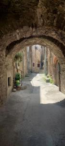 an alley with an archway in a stone building at Studio Isaline RDC in Saint-Ambroix
