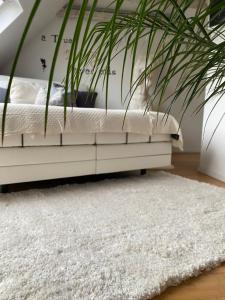 a bedroom with a white bed and a white rug at private Wellness Suiten mit Whirlpool in Essen