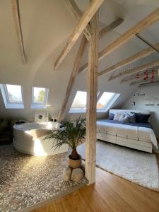 a bedroom with a bed and a tree in a room at private Wellness Suiten mit Whirlpool in Essen