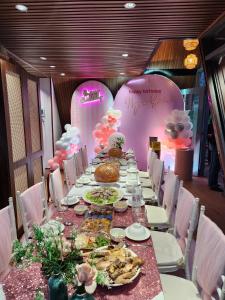 a long table with plates of food on it at Lúa Homestay in Soc Trang