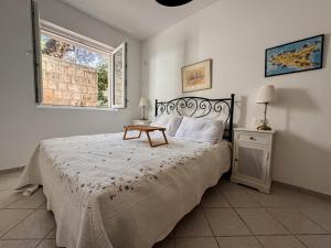 a bedroom with a bed with a table on it at Apartment Radovic in Sveti Stefan