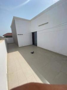 a empty room with a white wall and a floor at IDMAN RESIDENCE in Ambouli