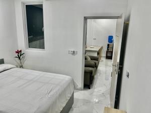 a bedroom with a bed and a living room at Dhonveli Stay in Hulhumale