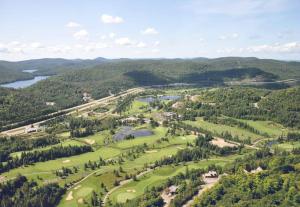 an aerial view of a golf course with a lake at Le Chamonix/Mountain view/Golf course/Activities! in Saint-Faustin