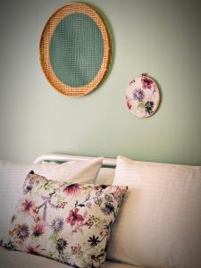 a bedroom with a bed with two plates on the wall at Caravin Wanderhome Acropolis, 1 min from Acropolis Museum in Athens