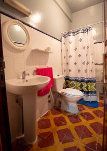 a bathroom with a sink and a toilet at Palma Ziz in Aït Athmane