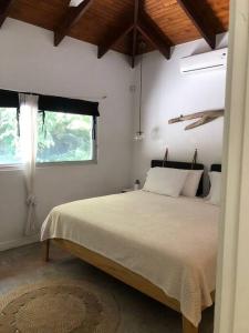 a bedroom with a large bed with a window at Casa Anna, Private Home, Guiones in Nosara +22 photos