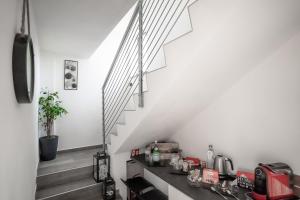 a kitchen with a counter and stairs in a house at Dolce Lago B&B in Calolziocorte