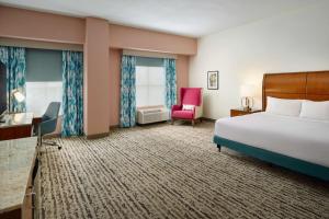 a hotel room with a bed and a chair at Hilton Garden Inn Atlanta Midtown in Atlanta