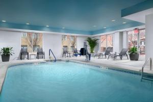 a pool in a hotel lobby with chairs and tables at Hilton Garden Inn Chattanooga Downtown in Chattanooga