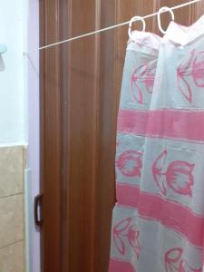 a towel hanging on a towel rack in a bathroom at Самостоятелна малка стая in Varna City