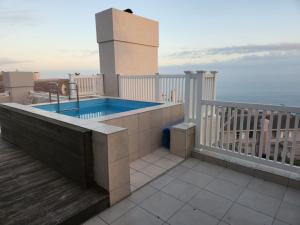 a swimming pool on the balcony of a building at Villa Penthouse 17-5 in Mossel Bay