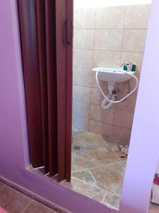 a bathroom with a sink and a shower stall at Самостоятелна малка стая in Varna City