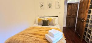 a bedroom with a large bed with two pillows at Luxury 3 Bed Apt in Camden in London