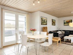 a dining room with a table and chairs at Three-Bedroom Holiday home in Brovst 31 in Brovst