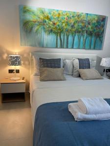 a bedroom with two beds and a painting on the wall at Allure Luxury Villas 3&4 Serenity Retreat in Skiathos