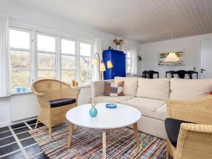 uma sala de estar com um sofá branco e uma mesa em Holiday home Brovst XI em Brovst