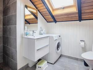 a bathroom with a washing machine and a sink at 7 person holiday home in Fjerritslev-By Traum in Slettestrand +17 photos