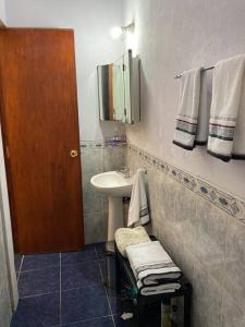 a bathroom with a sink and a mirror at La casita de Morgan in Mercedes