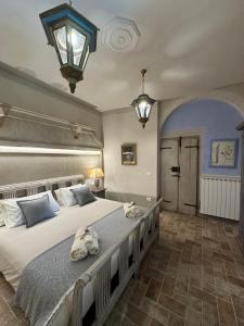 a bedroom with a large bed with towels on it at Casale San Giorgio in Luco di Mugello