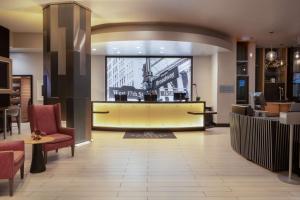 a lobby of a hotel with a waiting area at Embassy Suites By Hilton New York Manhattan Times Square in New York