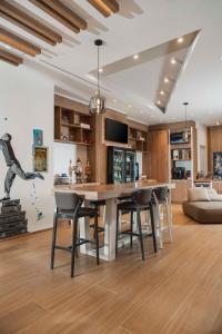 a kitchen and living room with a table and chairs at Hilton Garden Inn Padova City Centre in Padova