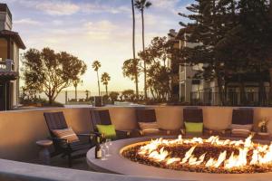 a large fire pit on a patio with chairs at Zachari Dunes on Mandalay Beach, Curio Collection by Hilton in Oxnard