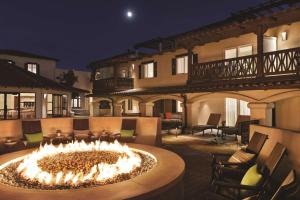 a fire pit in the middle of a patio at night at Zachari Dunes on Mandalay Beach, Curio Collection by Hilton in Oxnard