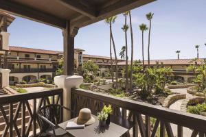 a balcony with a table and chairs and a building at Zachari Dunes on Mandalay Beach, Curio Collection by Hilton in Oxnard