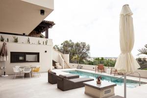 a patio with a pool and a couch and a table at Orama Luxury Suite 3 Bedrooms with Private Pool in Hersonissos