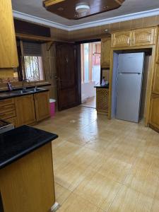 a large kitchen with wooden cabinets and a kitchen island at شقه فخمه مفروشه بالكامل في اربد in Irbid