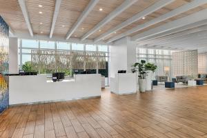 an office lobby with white desks and chairs and windows at Marriott's Crystal Shores in Marco Island