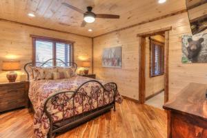 a bedroom with a bed in a room with wooden walls at Parkview Lodge In Gatlinburg in Gatlinburg +61 photos