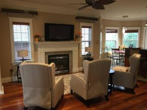 a living room with chairs and a fireplace with a tv at Beautiful and Peaceful Home in Halifax