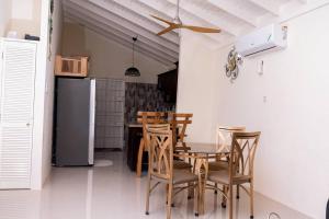 a kitchen with a table and chairs and a refrigerator at Your ideal home away from home. in The Rock