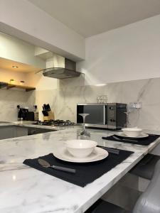 a kitchen with two white bowls on a counter at Central entire studio apartment in London