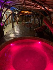 a hot pink bath tub in the middle of a deck at Pousada Egrégora in Sao Jorge