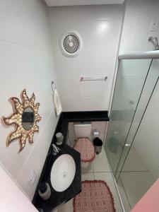 a small bathroom with a toilet and a shower at Premier do Atalaia M203 in Salinópolis