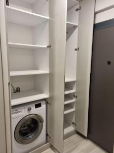 a white closet with a washing machine in it at Belek’de 2+1 klimalı havuzlu lüks daire in Belek
