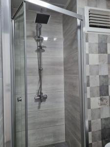 a shower with a glass door in a bathroom at Belek’de 2+1 klimalı havuzlu lüks daire in Belek