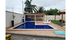 a swimming pool in the backyard of a house at DUNAS RESIDENCE CASA 12 in Santo Amaro