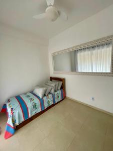 a bedroom with a bed and a large mirror at Espaço Vitória Imperial in Guapimirim