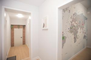 a hallway with a wall mural of a map of the world at Aerostay Hostel in Moreira