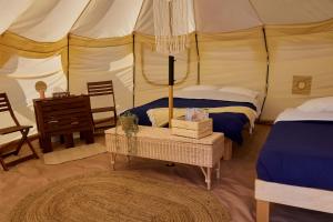 a bedroom with a tent with a bed and a table at Hôtel UNIQ - Domaine Saint-Bernard in Mont-Tremblant